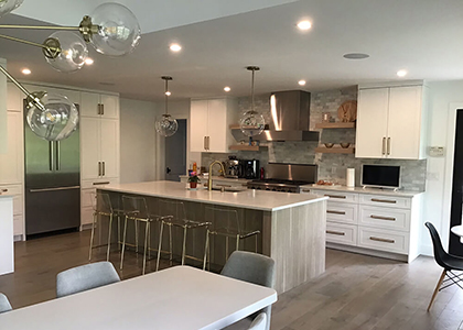 Briarcliff, NY - White Shaker Cabinetry by UltraCraft - Arctic White Perimeter with Slab Door Island